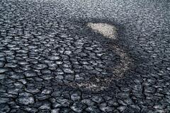 Variety Of Cracks And A Red Rock