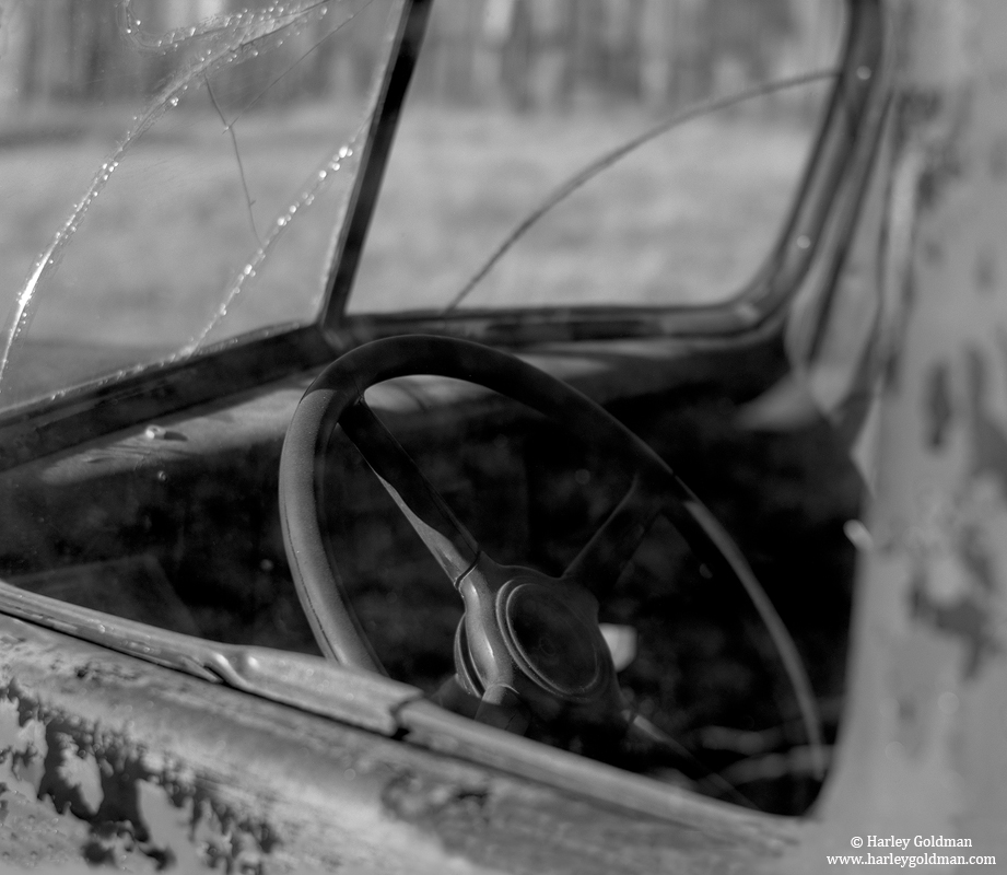 The driver's side window of an old truck at Bodie.